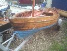 Rose - a very "pretty" traditional gaff rigged day sailer with tan sails, floorboards, oars, rowlocks etc. & a custom road trailer.