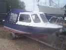 Suzy - A very nice pleasure launch with a custom trailer, "as new" engine, full canopy & lots of cruising equipment.
